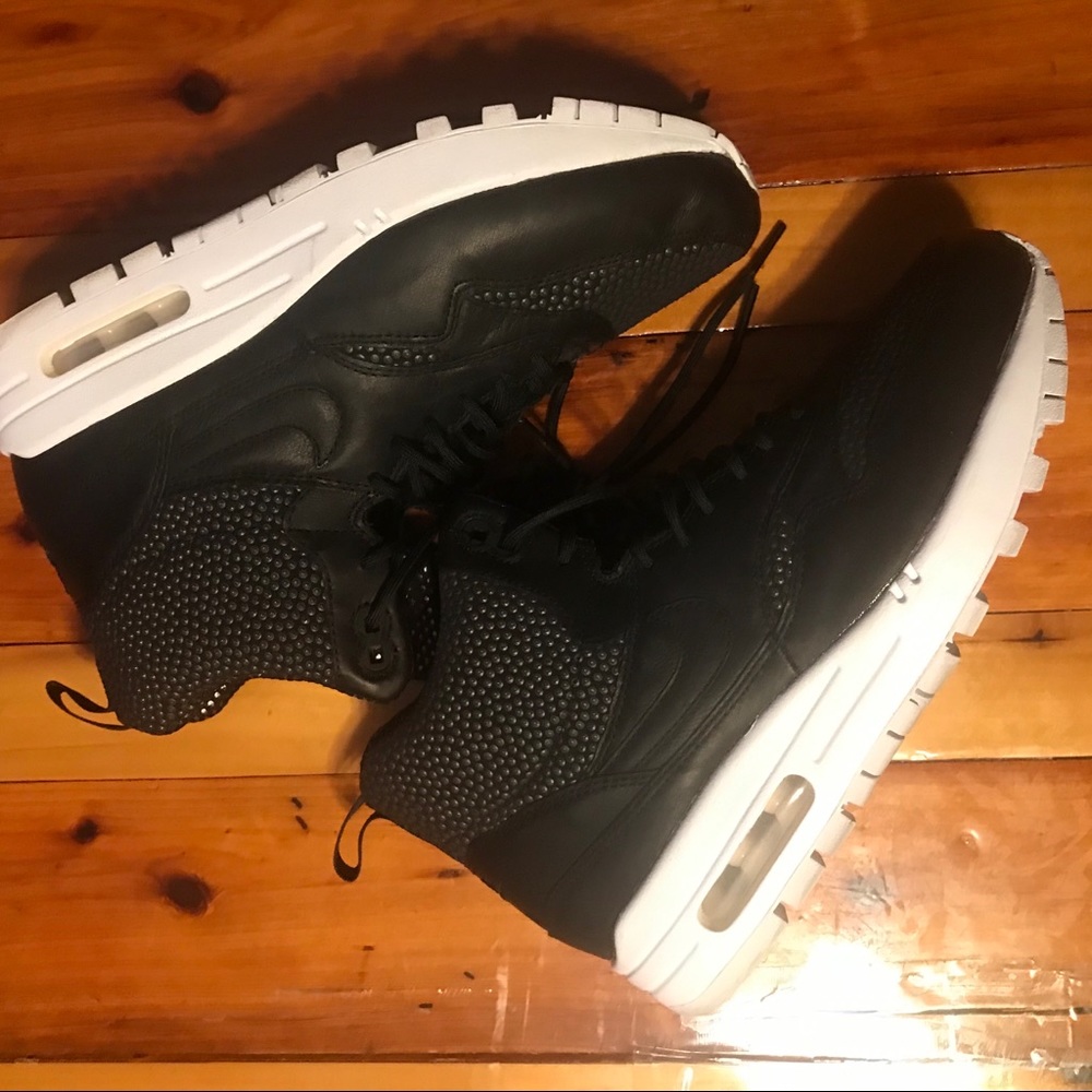 Ladies Nikes Size: 8.5 Black with beaded design.